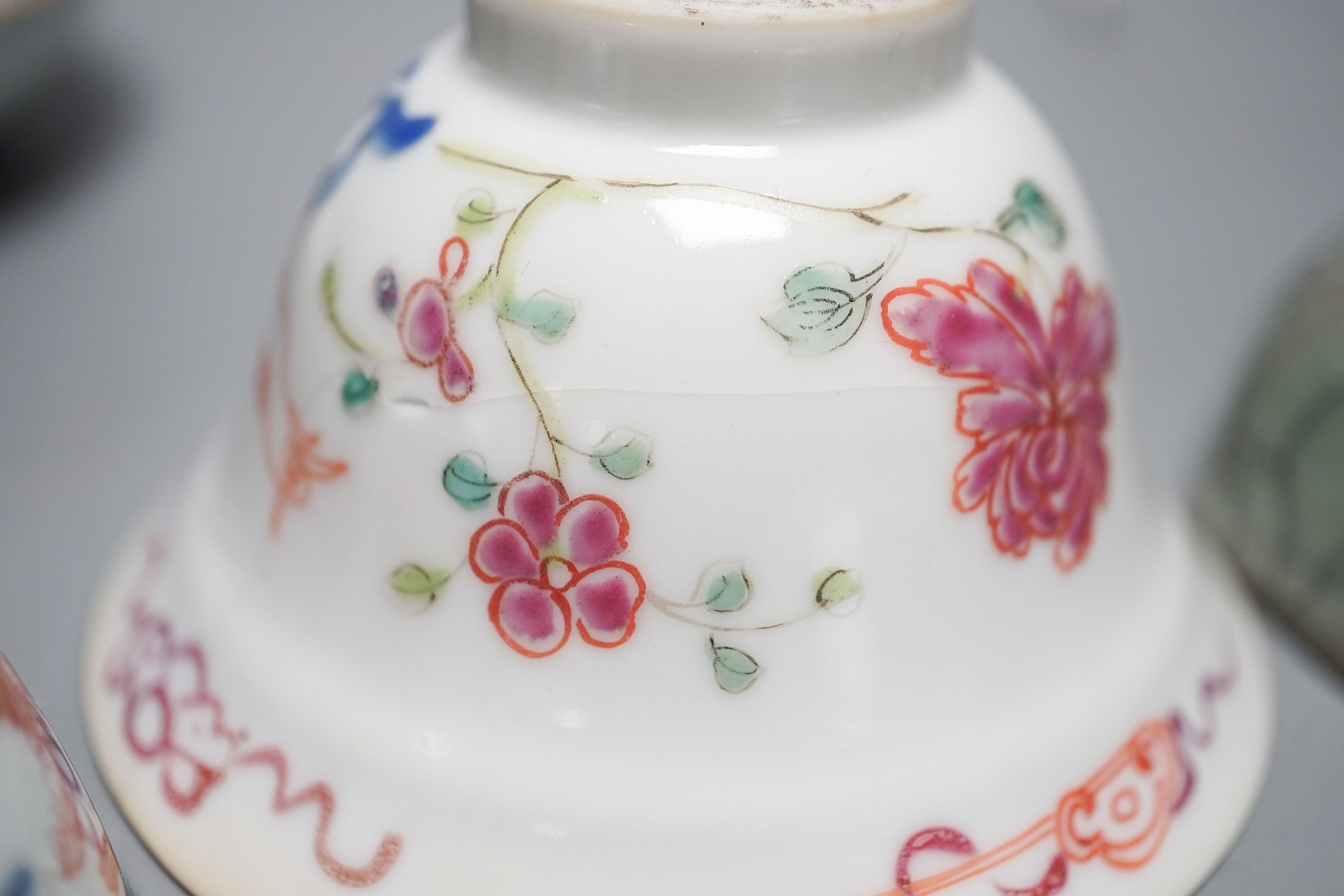 A Chinese Imari tea bowl and saucer, a famille rose tea bowl, a saucer and a celadon glazed cup